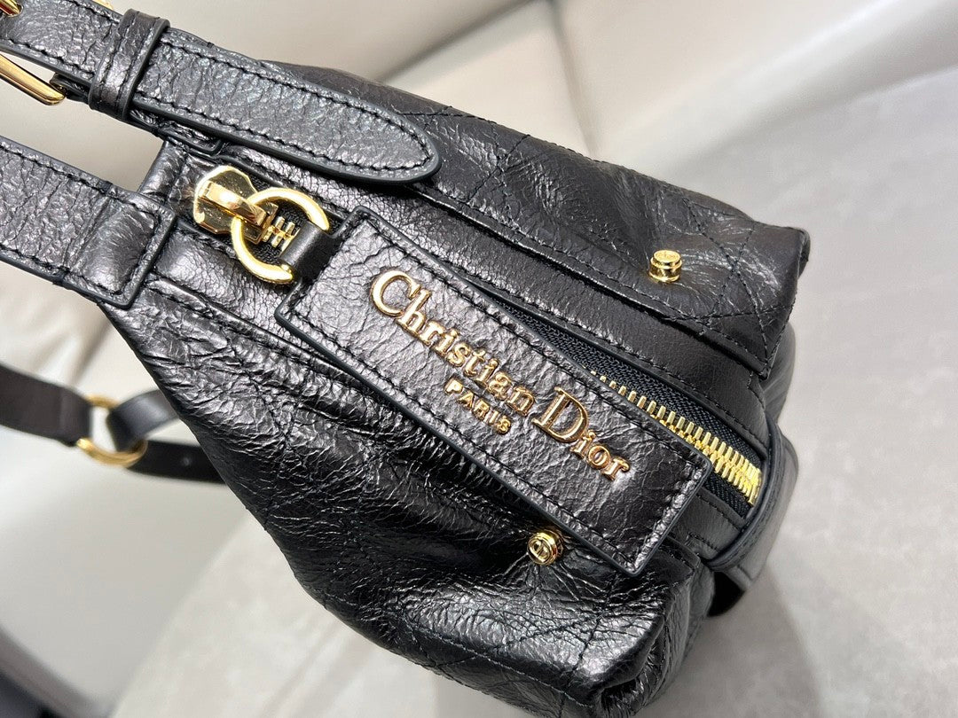 Distinctive black armpit bag, accentuated by metal accessories, a must - have for chic style.