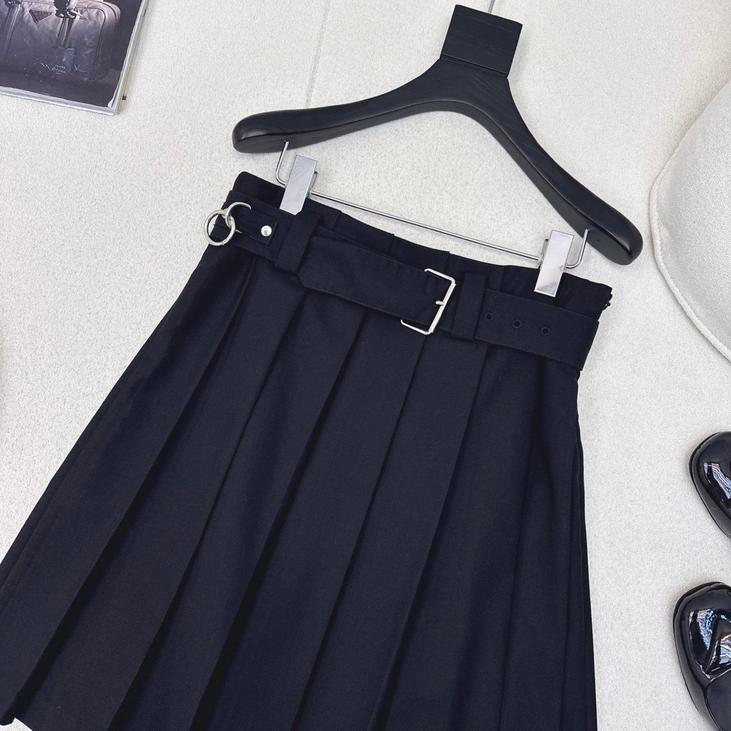 Pleated A - line skirt with classic belt embellishment