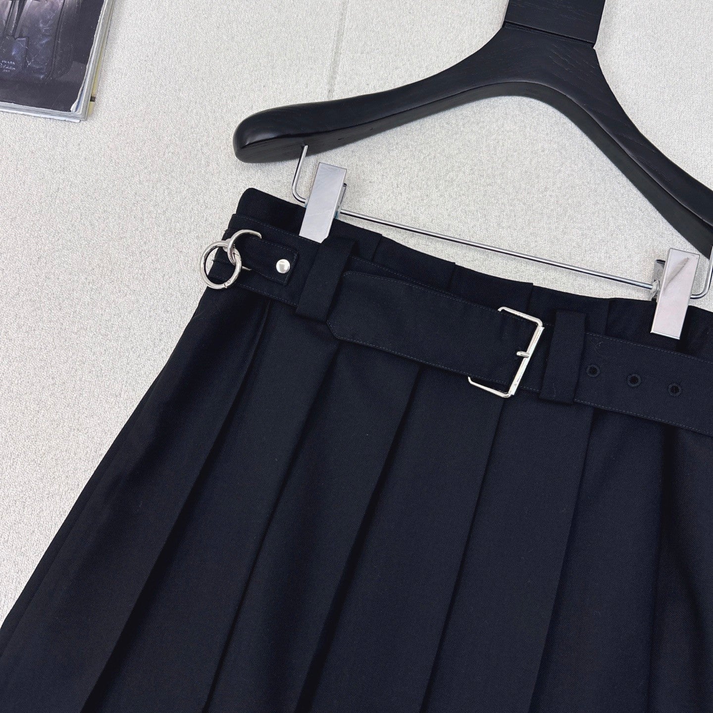 Pleated A - line skirt with classic belt embellishment