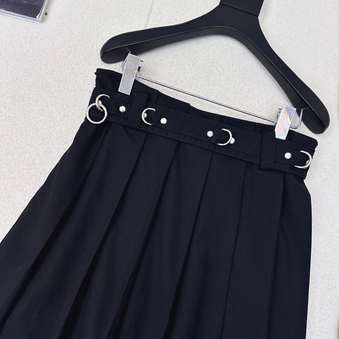 Pleated A - line skirt with classic belt embellishment