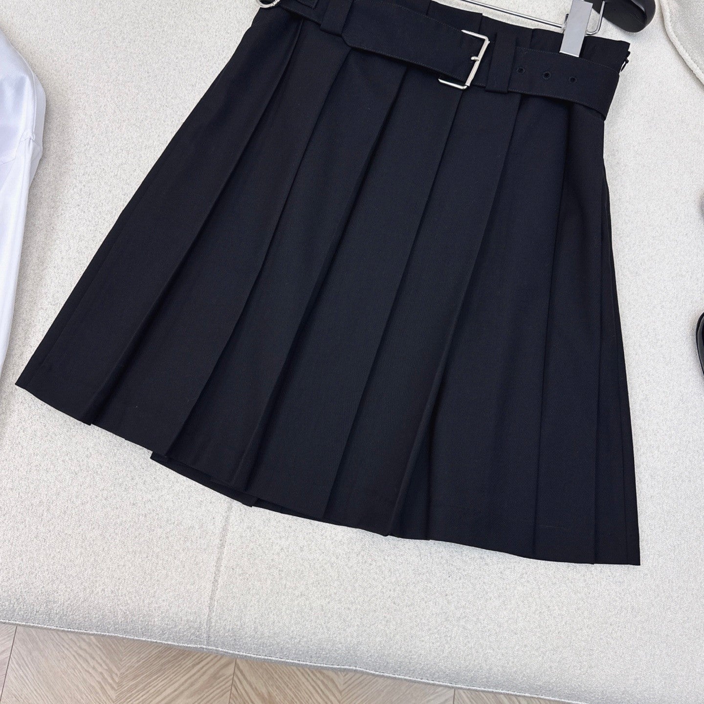 Pleated A - line skirt with classic belt embellishment