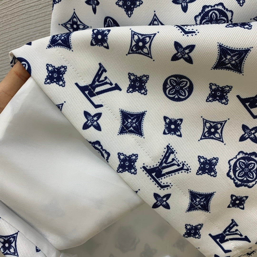 Sleeveless dress with letter logo prints, half - zippered front placket, and contrast - colored convertible collar