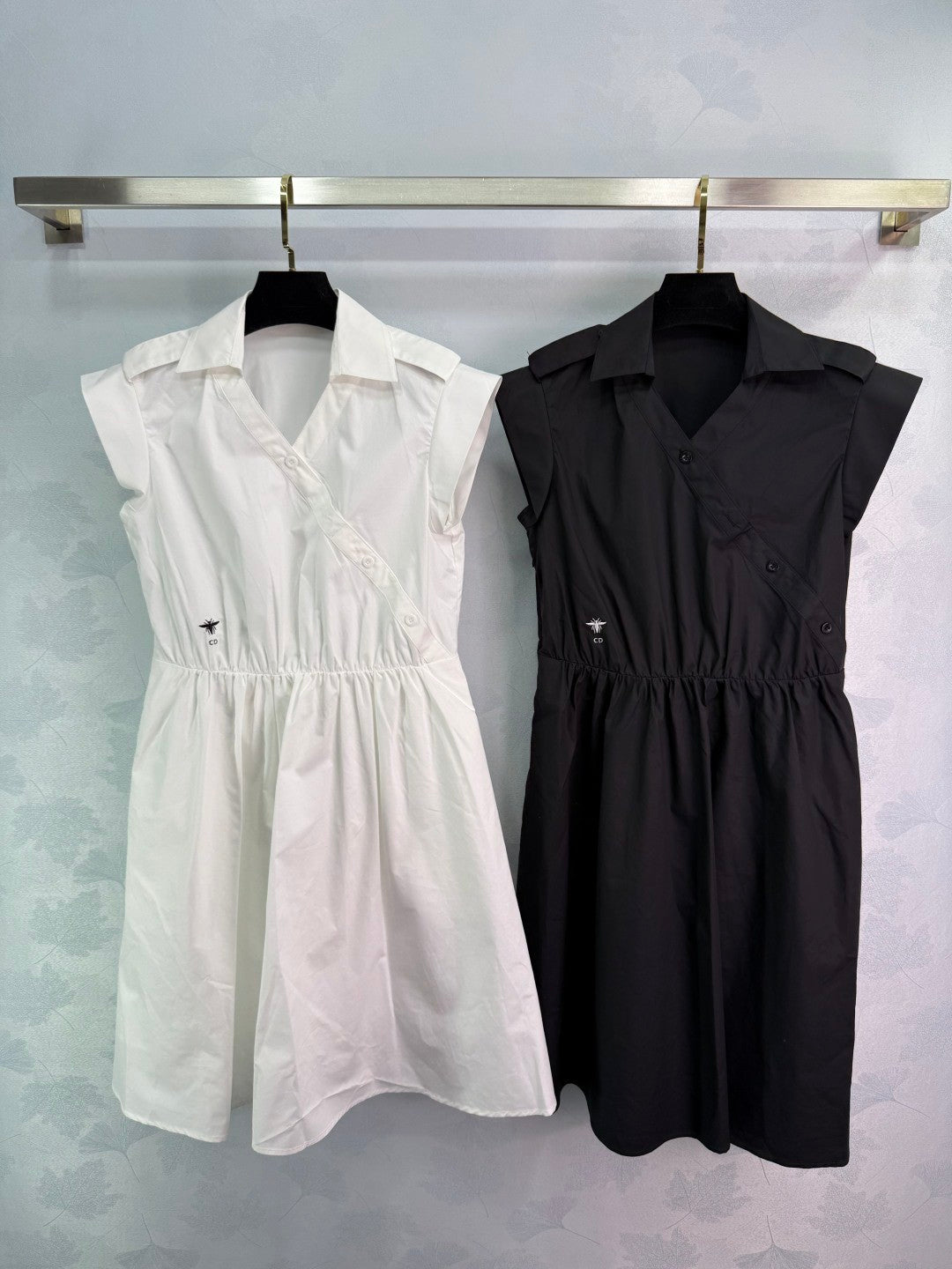 Dress with notched collar, small V - neck, ruffled sleeves and a cinched waist. Made of custom - sourced, pure cotton material.
