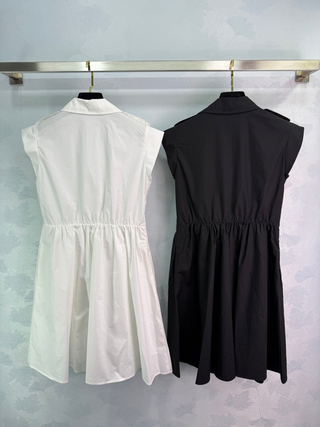Dress with notched collar, small V - neck, ruffled sleeves and a cinched waist. Made of custom - sourced, pure cotton material.